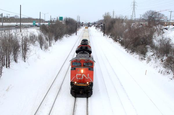 A Canadian Natio<em></em>nal Railway train travels eastward on a track in Montreal, February 22, 2015. REUTERS/Christinne Muschi/File Photo