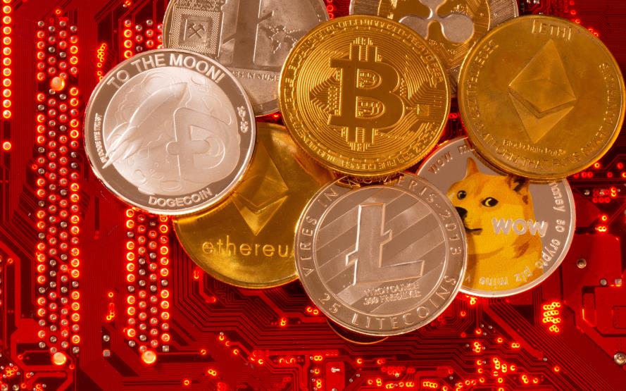 Representations of cryptocurrencies Bitcoin, Ethereum, DogeCoin, Ripple, Litecoin are placed on PC motherboard in this illustration taken, June 29, 2021. REUTERS/Dado Ruvic/Illustration/File Photo
