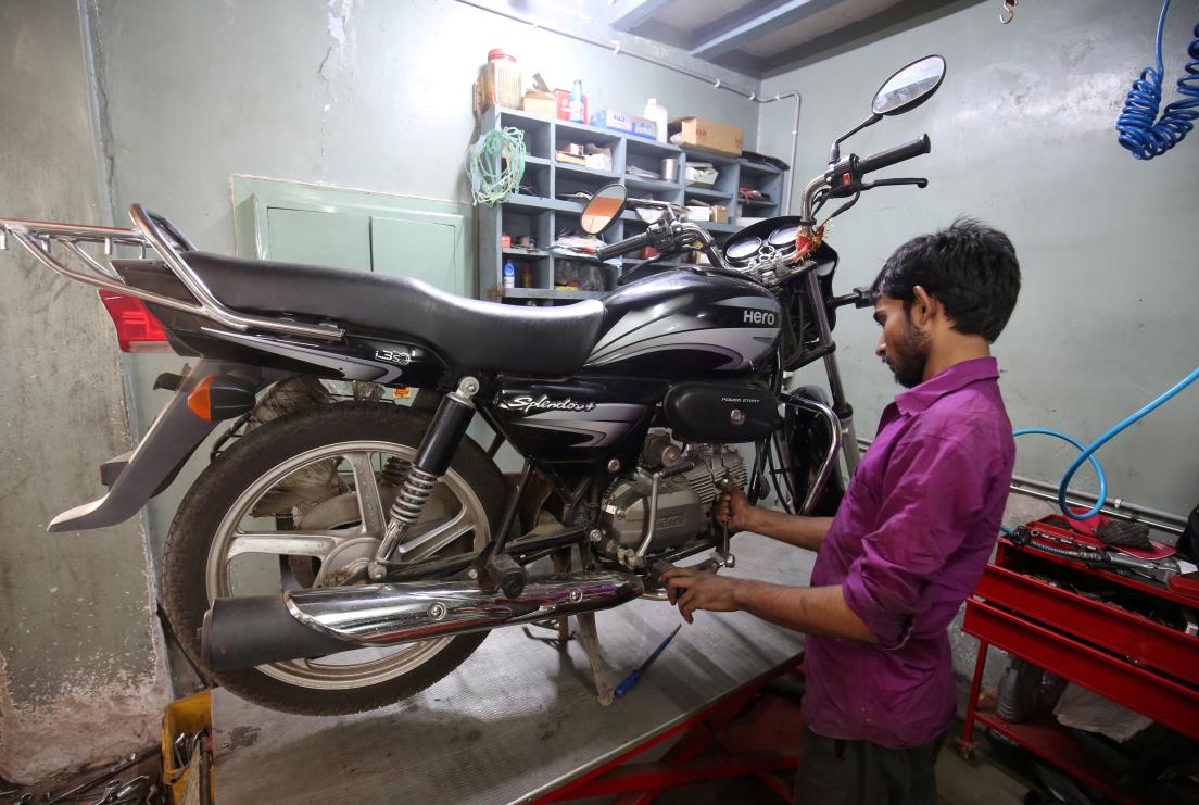An employee works on a motorbike inside a Hero MotoCorp service station in Ahmedabad, India, October 16, 2018. REUTERS/Amit Dave
