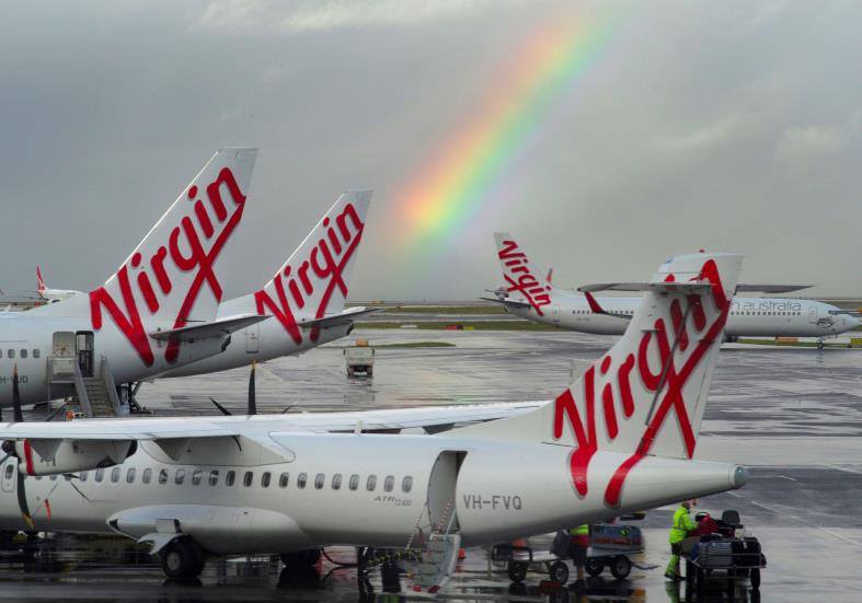 A rainbow from a passing rain shower sits over Virgin Australia aircraft at Sydney's Airport in Australia, August 5, 2016.  REUTERS/Jason Reed/File Photo