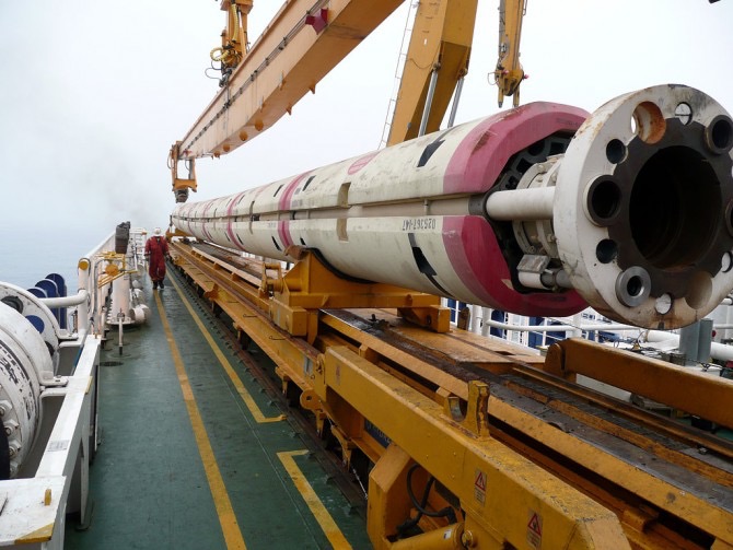 Laid out on the deck, the encased pipe is almost the length of the boat