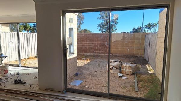 Unfinished home looking from interior to back yard.