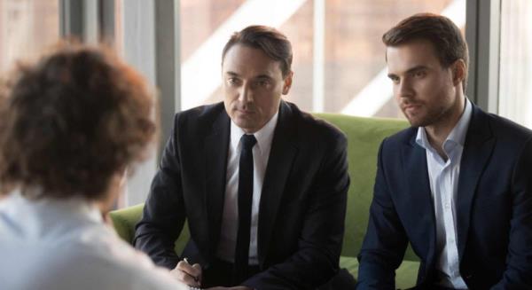 Two Serious Recruiters Hr Listening To Applicant At Job Intervie
