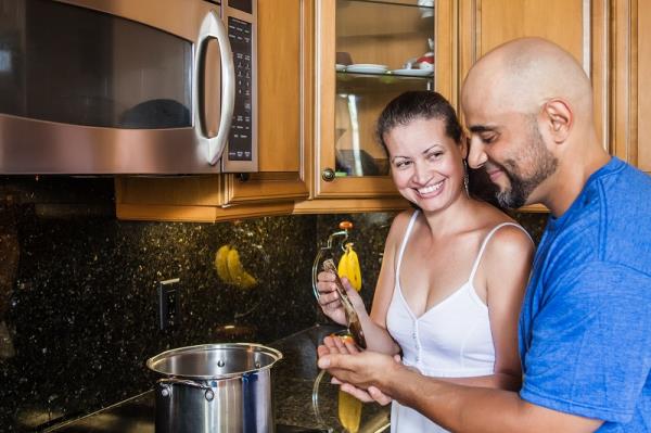 Couple cooks together in kitchen before renewing a green card after 2 years